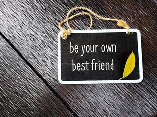 Chalkboard on wood background with handwritten text BE YOUR OWN BEST FRIEND, concept of be kind to yourself, the only friend to have for life, guide yourself to greatness with self-compassion