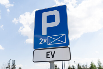 Electric vehicles charging station point. D-18a car parking reserved space sign and EV plate, marking of EV cars charger station, road signs in Poland.