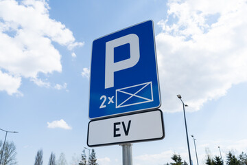 D-18a car parking reserved space sign and EV plate, marking of electric vehicle charging station point. EV cars charger station, road signs in Poland. - obrazy, fototapety, plakaty