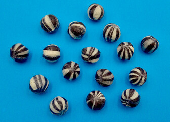 Humbug balls against a blue background