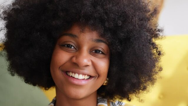 Cheerful black woman with curly hair