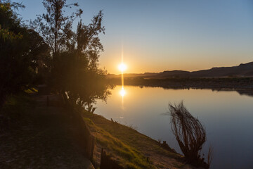 Sunset over the Orange river, on the border between Namibia and South Africa.