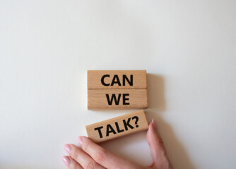 Can we talk symbol. Concept word Can we talk on wooden blocks. Businessman hand. Beautiful white background. Business and Can we talk concept. Copy space