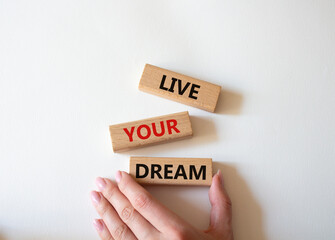 Live your Dream symbol. Wooden blocks with words Live your Dream. Beautiful white background. Businessman hand. Business and Live your Dream concept. Copy space.