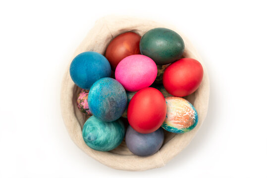 Multi colors Easter eggs in the woven basket isolated on white background with clipping path