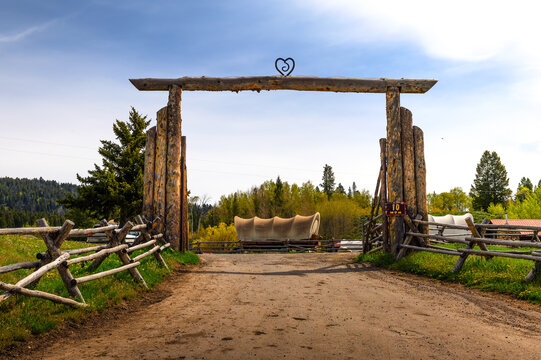 Moran, Wyoming, USA - June 8, 2022 : Entrance to Buffalo Valley Ranch located at the Snake River with historic carriages in the background. This ranch is located in Grand Teton National Park.