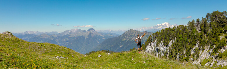 Naklejka na ściany i meble Man hiking trail with beautiful panorama
