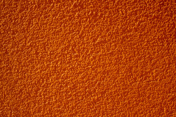 Fototapeta premium Abstract orange background. Plastered textured wall.