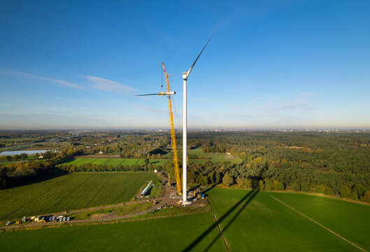 Aerial view of wind turbine under construction in field