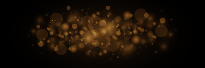 The dust is yellow. Golden sparks and golden stars shine with a special light. Vector sparkles on a black background. Christmas light effect. Shiny magical dust particles.	