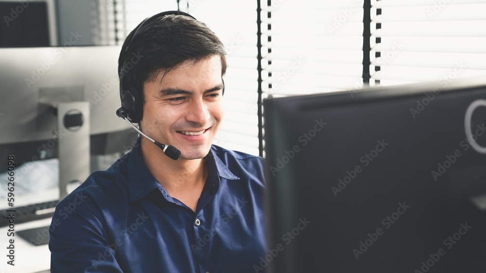 Aufkleber young competent asian male call center agent working at his computer while simultaneously speaking w