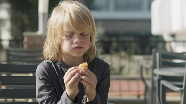 boy eating chicken nuggets in fast food McDonalds Restaurant 23.03.20 Kemer Turkey.
