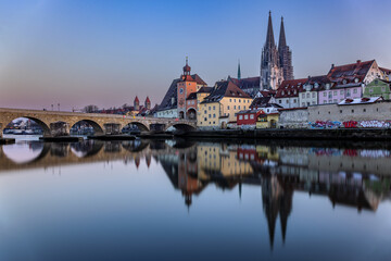 View over the Danube river towards the Regensburg cathedral and the stone bridge in Regensburg, Bavaria, Germany.