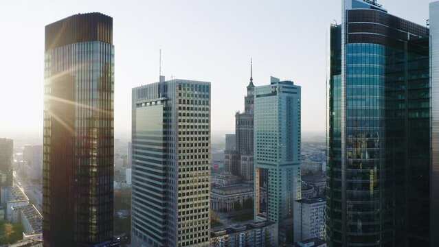 Drone shot cityscape, establishing aerial view Warsaw city, Poland. Urban skyline cinematic downtown, high rise office skyscrapers and bright sun beams, modern architecture buildings, business center