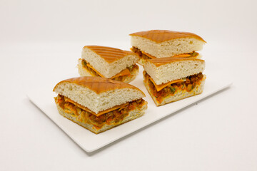 Sandwich with pistasso, cheese, lettuce, and toasted bread. Front view isolated on white background.