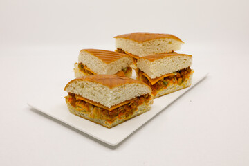 Sandwich with pistasso, cheese, lettuce, and toasted bread. Front view isolated on white background.