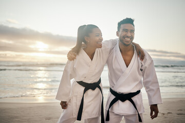 Theyre a kickass karate couple. Shot of two young martial artists practicing karate on the beach. © Siphosethu Fanti/peopleimages.com