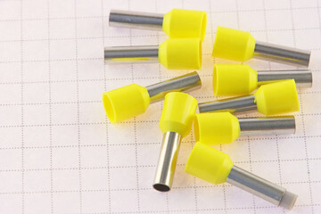 Metal tips with colored insulators for connecting copper electrical wires. Close-up.