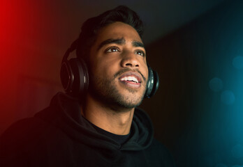 Gaming is life. Cropped shot of a handsome young male gamer playing video games in a dark room. © Samir H/peopleimages.com