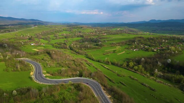 Curved road in vicinity of Apuseni Mountains, Romania.
Drone footage.