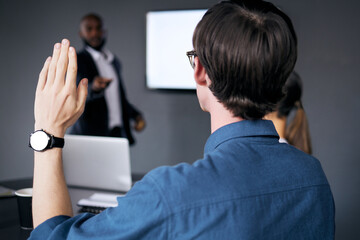 Together we can do something wonderful. Shot of a unrecognizable businessman lifting his hand in a office meeting.