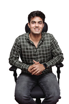 An eligible Indian bachelor or job applicant for interview. Innocent Indian young man in formal checkered shirt simply sitting on an office chair for interview isolated on a PNG background.