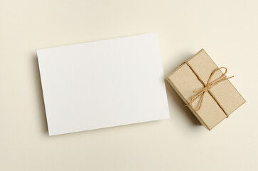 Blank greeting card mockup with gift box in paper background, empty mockup with copy space