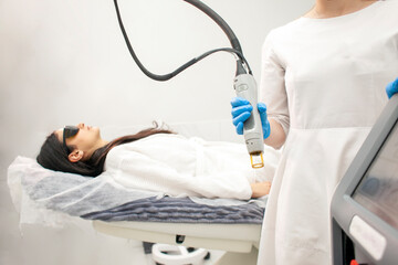 doctor cosmetologist in uniform holds alexandrite laser, professional hair removal in cosmetology...