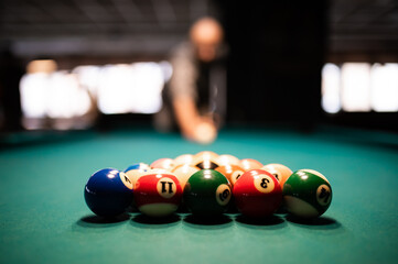 Man preparing to break spheres in billiard