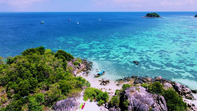 couple with a kayak on a small Island in front of the Island of Ko Lipe Thailand, Kla Island