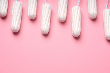 Medical female tampon on a pink background. Hygienic white tampon for women. Cotton swab. Menstruation, means of protection. Tampons on a red background.	 - obrazy, fototapety, plakaty