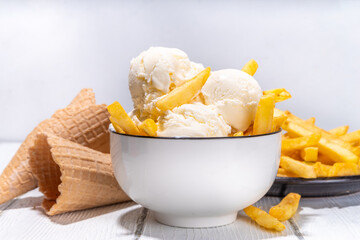 Trendy french fries ice cream, Vanilla icecream with original french fries potato flavor, white wooden background copy space