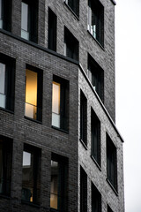 Brick House Building in Hamburg Germany, lights turned on in one window