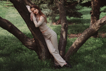 glamour young lady poing in the green forest