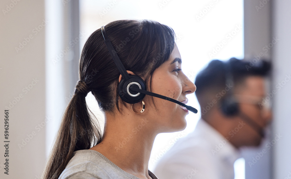 Aufkleber Navigating her way to the solution. Shot of a young call centre agent working in an office.