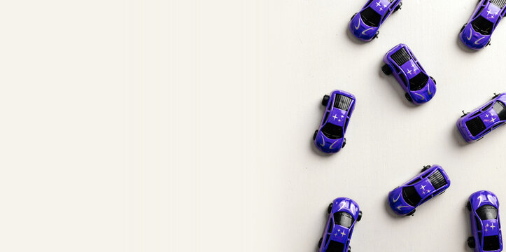 Children's toy cars arranged on a white table, top view, cars in blue, space for text
