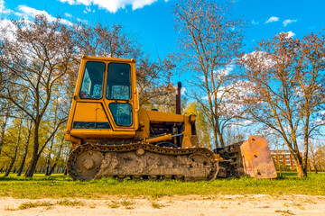 Side view of yellow dirty crawler bulldozer