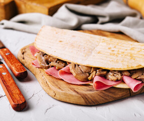 Homemade flatbread with ham and mushrooms