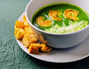 Broccoli green cream soup with shrimps