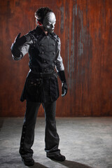 A young man in a Victorian-style suit, a retro character. Antihero or tragic character, in a mysterious silver mask