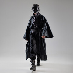 Urbantech outfit cyber style, a young man in stylish black clothes and a mirror mask on the whole...