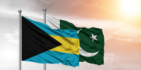 Flags of Pakistan and The Bahamas friendship flag waving on the sky with beautiful sky.