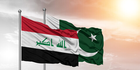 Flags of Pakistan and Iraq friendship flag waving on the sky with beautiful sky.