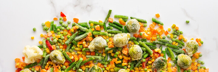 Frozen vegetable mix banner, frozen green beans and broccoli, corn and carrots, brussels sprouts and cauliflower, peas and bell peppers, copy space, top view