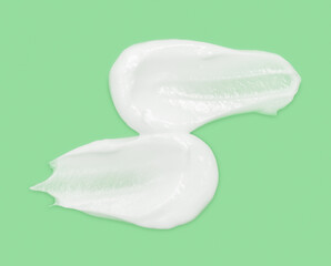 White cosmetic cream texture skincare lotion swatch. Face creme body moisturizer, hair conditioner smear smudge stroke on color background. Creamy beauty product close up. Shampoo, balm. Ointment