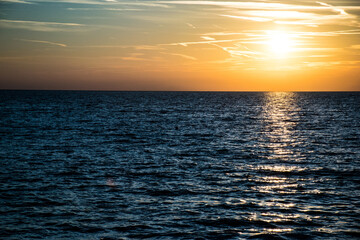 Sunset on the wavy Ocean with clouds, in Umag, Croatia