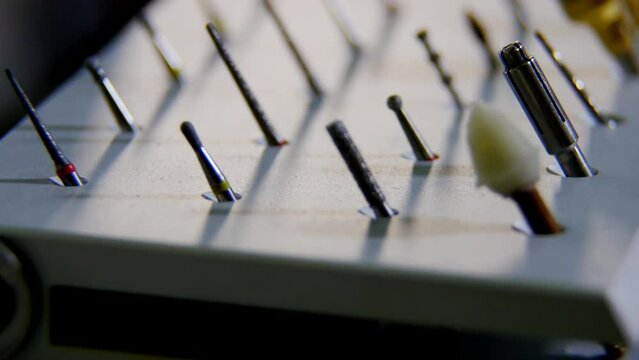 Sterile dental drill set on special stand in dentist office. Kit consists of diamond-coated dental burs and metal tools for examination and treatment