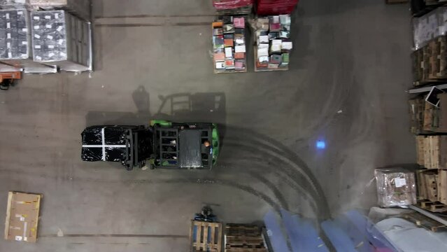 Top down view on forklift transport pallet ready to shipment in busy warehouse