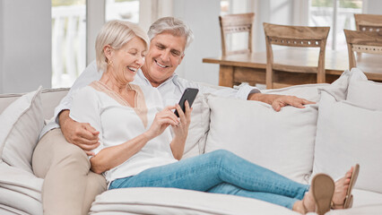 Together is my favorite place to be. Shot of a elderly couple using a cellphone at home.