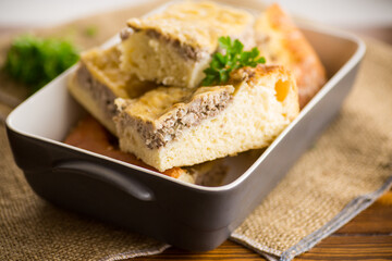 Cooked meat pie, pieces in a plate